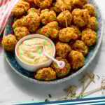 Pinterest graphic for Sausage Balls recipe. Image shows a platter of Sausage Balls with bowl of dipping sauce. Text says, "Sausage Balls simplejoy.com."