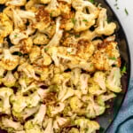 overhead of a plate of air fried cauliflower sprinkled with parsley