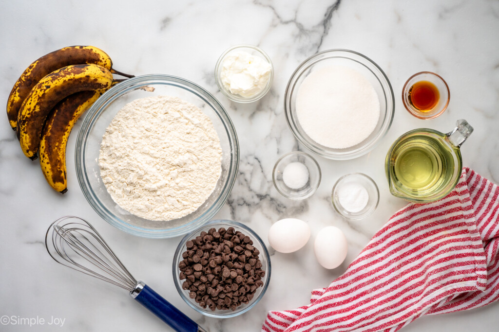 Overhead view of ingredients on countertop for banana chocolate chip muffins recipe - 6