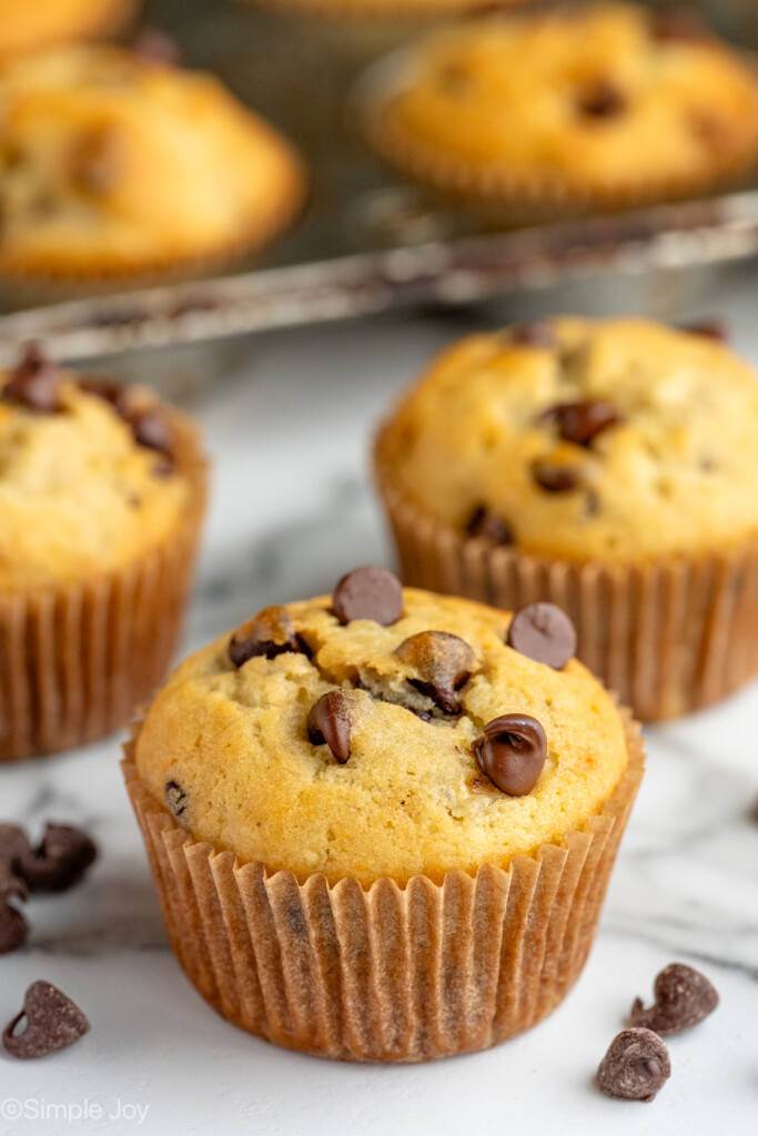 banana chocolate chip muffins with chocolate chips beside - 5