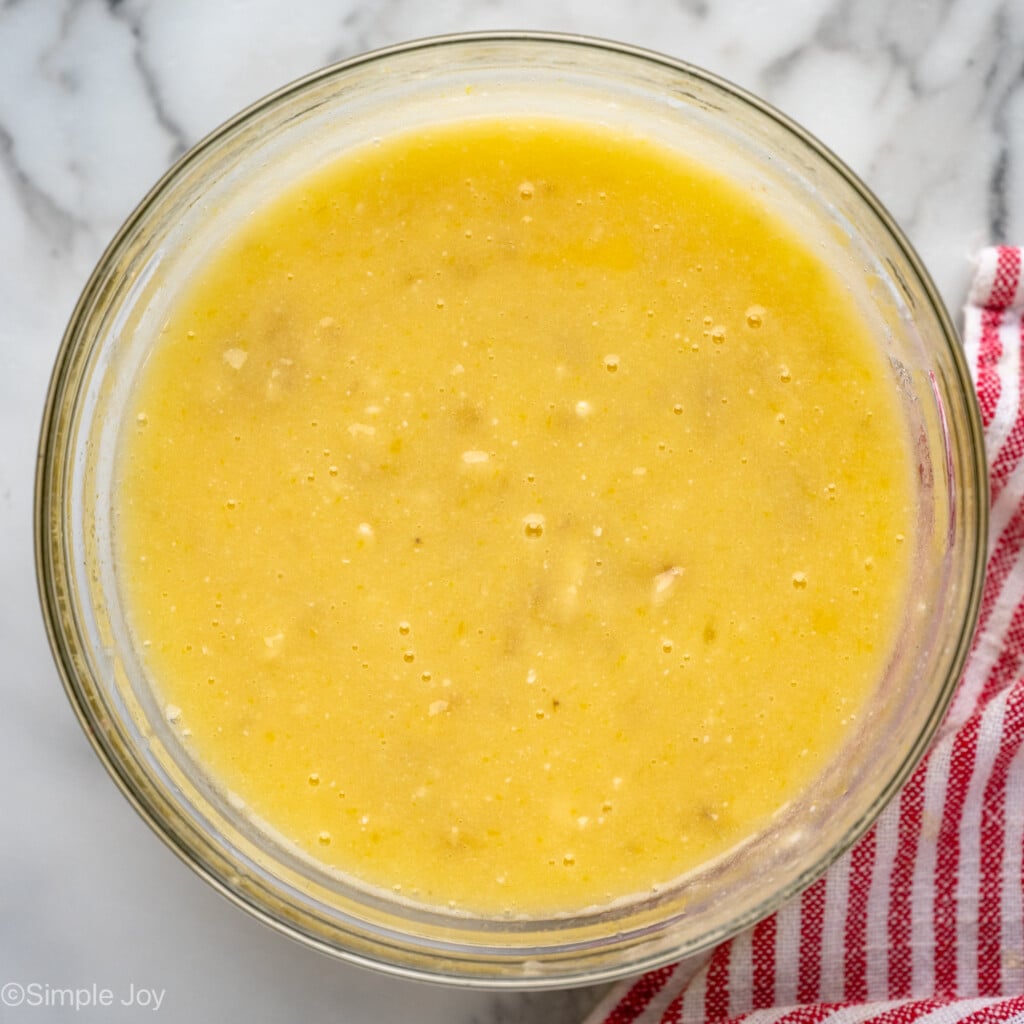 Overhead view of ingredients for banana chocolate chip muffins recipe in mixing bowl