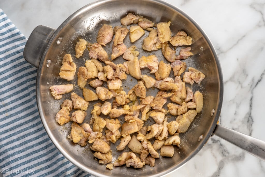 Overhead view of cooked chicken thighs in skillet for Bourbon Chicken recipe - 8