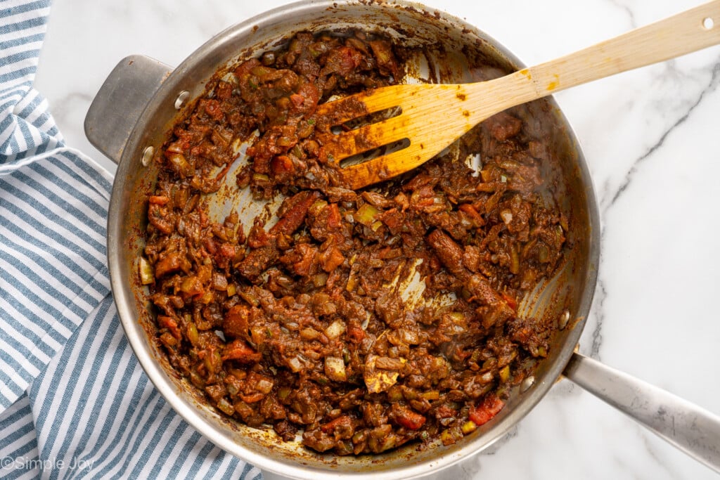 Overhead view of Chicken Curry recipe in skillet with wooden spoon - 7