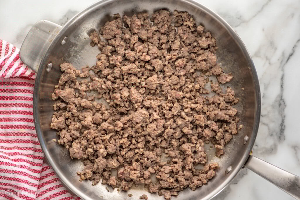 Overhead view of a skillet of ground cooked breakfast sausage for Hashbrown Breakfast Casserole recipe - 7
