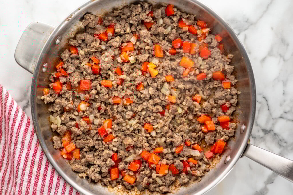 Overhead view of a skillet of ingredients for Hashbrown Breakfast Casserole recipe - 8
