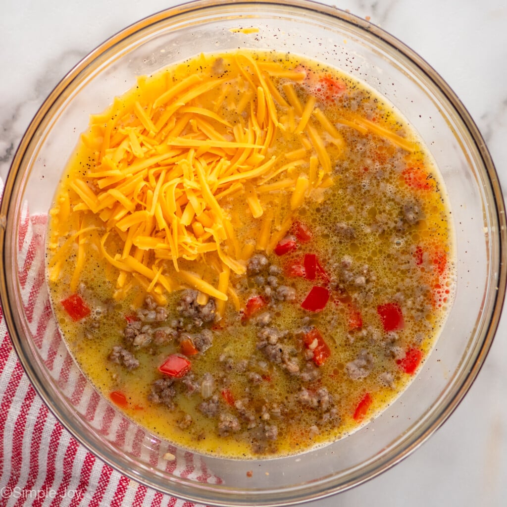 Overhead view of a mixing bowl of ingredients for Hashbrown Breakfast Casserole recipe