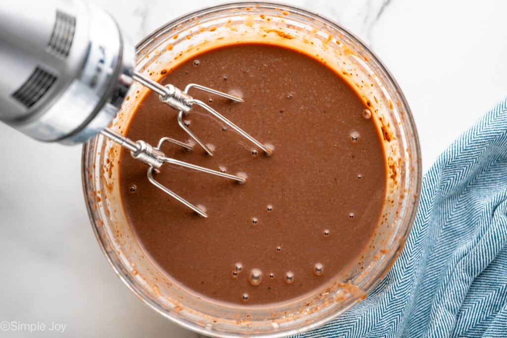 Overhead view of a mixing bowl of Pudding Shots recipe with hand mixer after beating. - 6