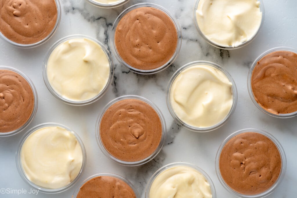 Overhead view of Pudding Shots in cups on countertop. - 8