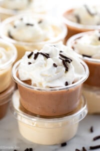 Stacks of Pudding Shots garnished with whipped cream and sprinkles - 10