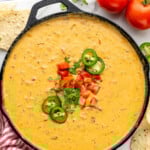 Pinterest graphic for Rotel Dip recipe. Text says, "the best Rotel Dip recipe simplejoy.com." Image shows overhead view of a skillet of Rotel Dip garnished with diced tomatoes, jalapenos, and cilantro. Tortilla chips and tomatoes beside.