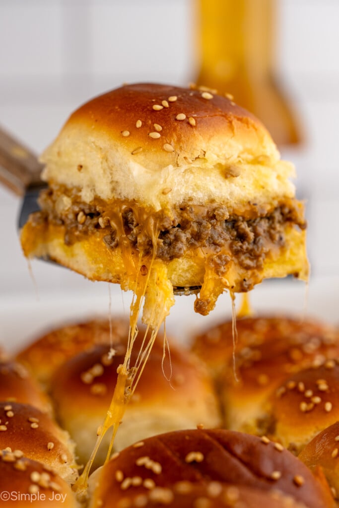 Side view of Cheeseburger Slider being pulled from baking dish - 4