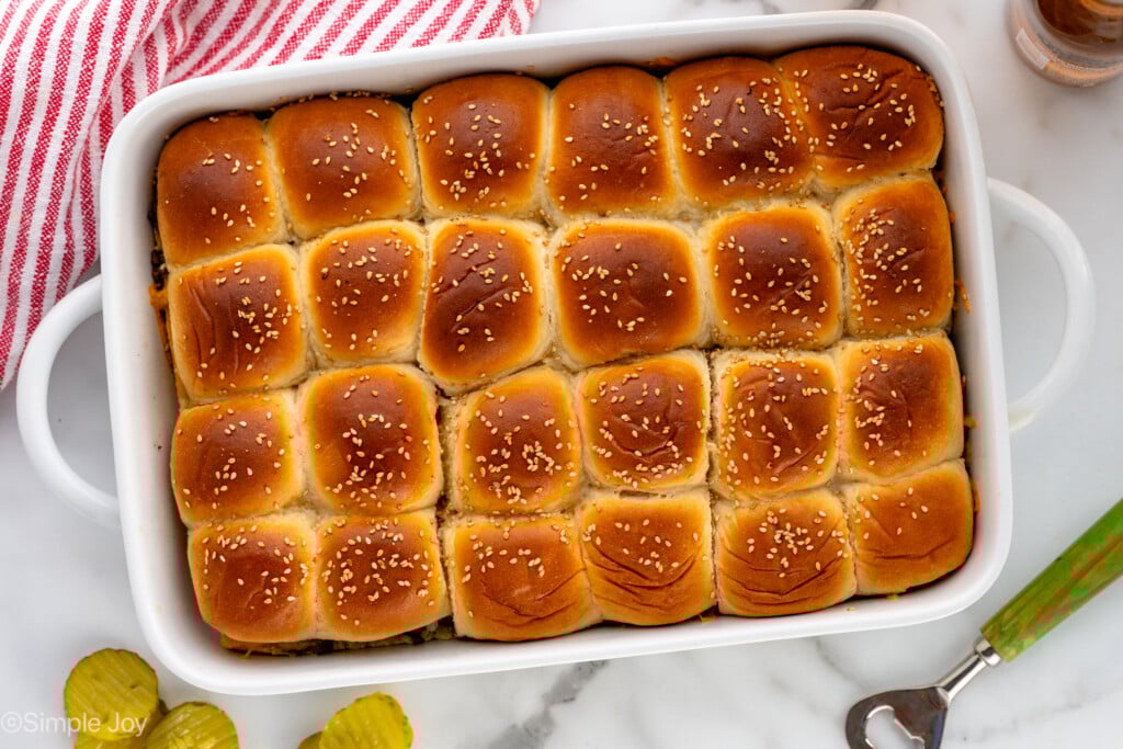 Overhead view of a baking dish of Cheeseburger Sliders garnished with sesame seeds - 10
