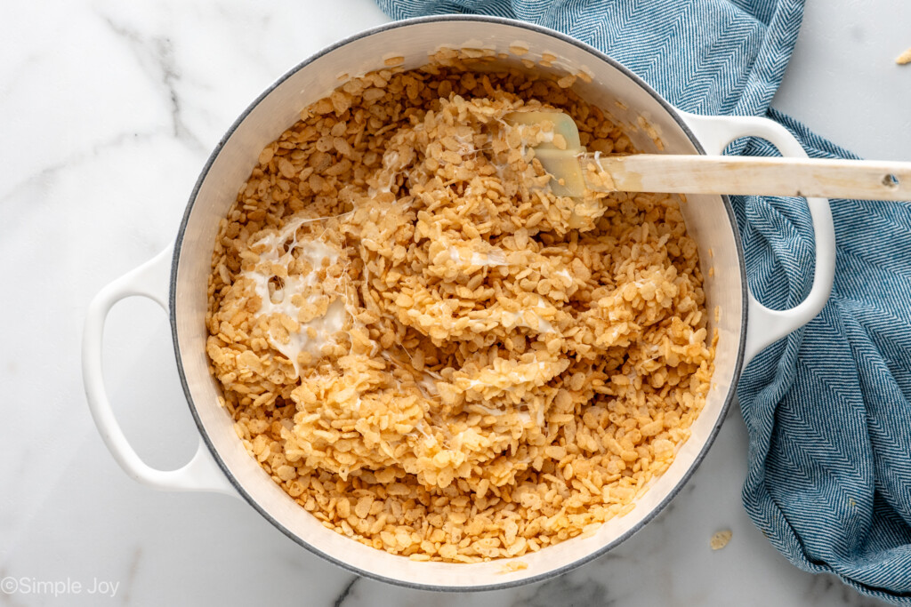 Overhead view of a large pot of rice krispies and marshallows for Oreo Rice Krispie Treats recipe with spatula. - 6