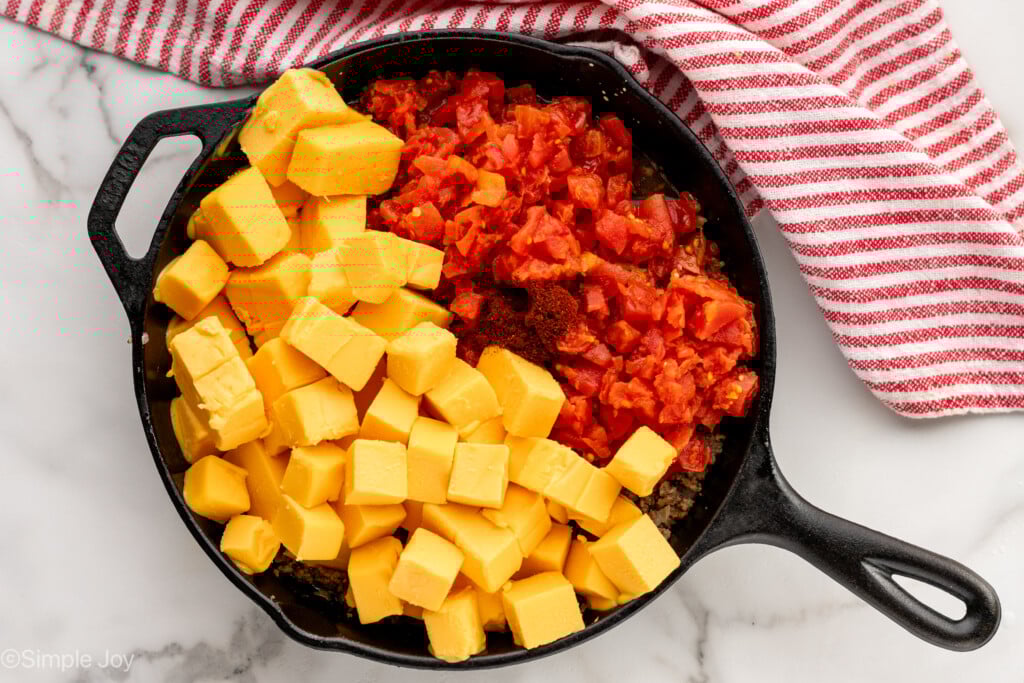 Overhead view of a skillet of ingredients for Rotel Dip recipe before melting - 6