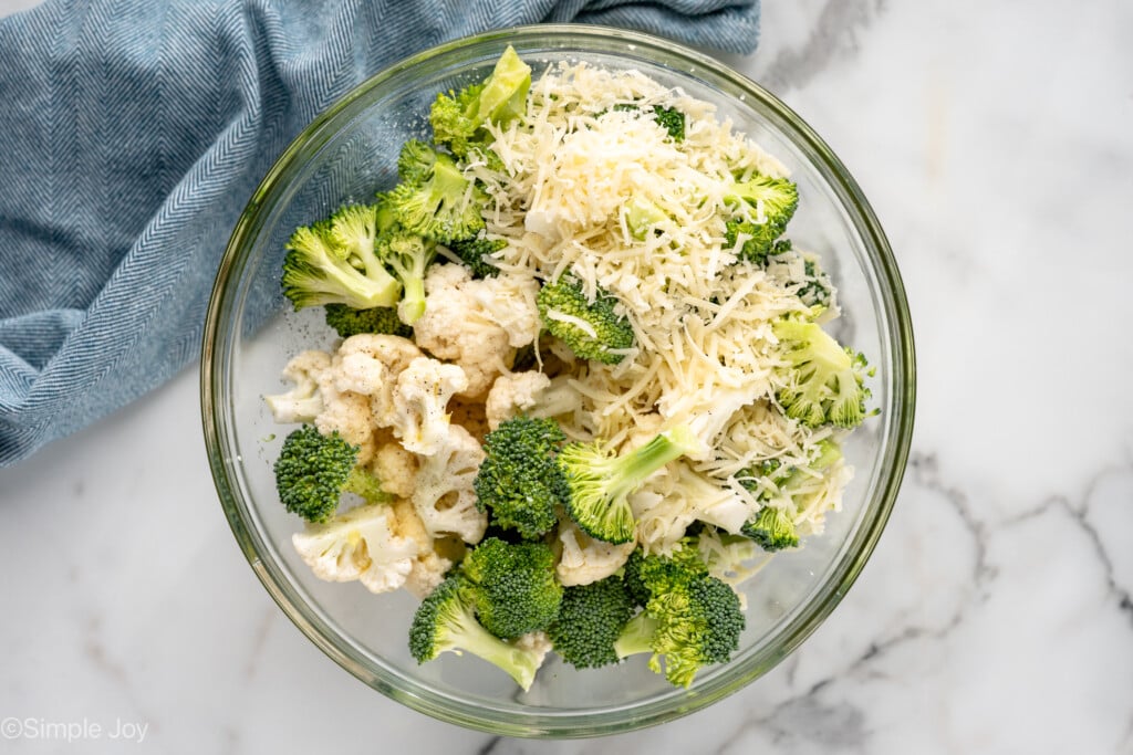Overhead view of a mixing bowl of ingredients for Roasted Broccoli and Cauliflower recipe - 4