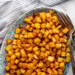 Pinterest graphic for Air Fryer Breakfast Potatoes recipe. Text says, "Air Fryer Breakfast Potatoes simplejoy.com." Image shows overhead view of a platter of Air Fryer Breakfast Potatoes with forks.
