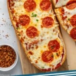 Pinterest graphic for French Bread Pizza recipe. Image shows overhead view of French Bread Pizza topped with pepperoni. Text says, "French Bread Pizza simplejoy.com."