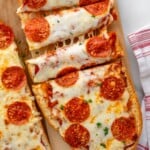 Pinterest graphic for French Bread Pizza recipe. Image shows overhead view of French Bread Pizza topped with pepperoni, cut into strips. Text says, "super easy French Bread Pizza simplejoy.com."