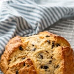 Pinterest graphic for Irish Soda Bread recipe. Text says, "the best Irish Soda Bread simplejoy.com." Image shows a loaf of Irish Soda Bread on a cooling rack.