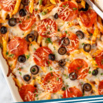 Pinterest graphic for Pizza Casserole recipe. Image shows a baking dish of Pizza Casserole with a spoon for serving, topped with black olives and pepperoni. Text says, "Pizza Casserole simplejoy.com."