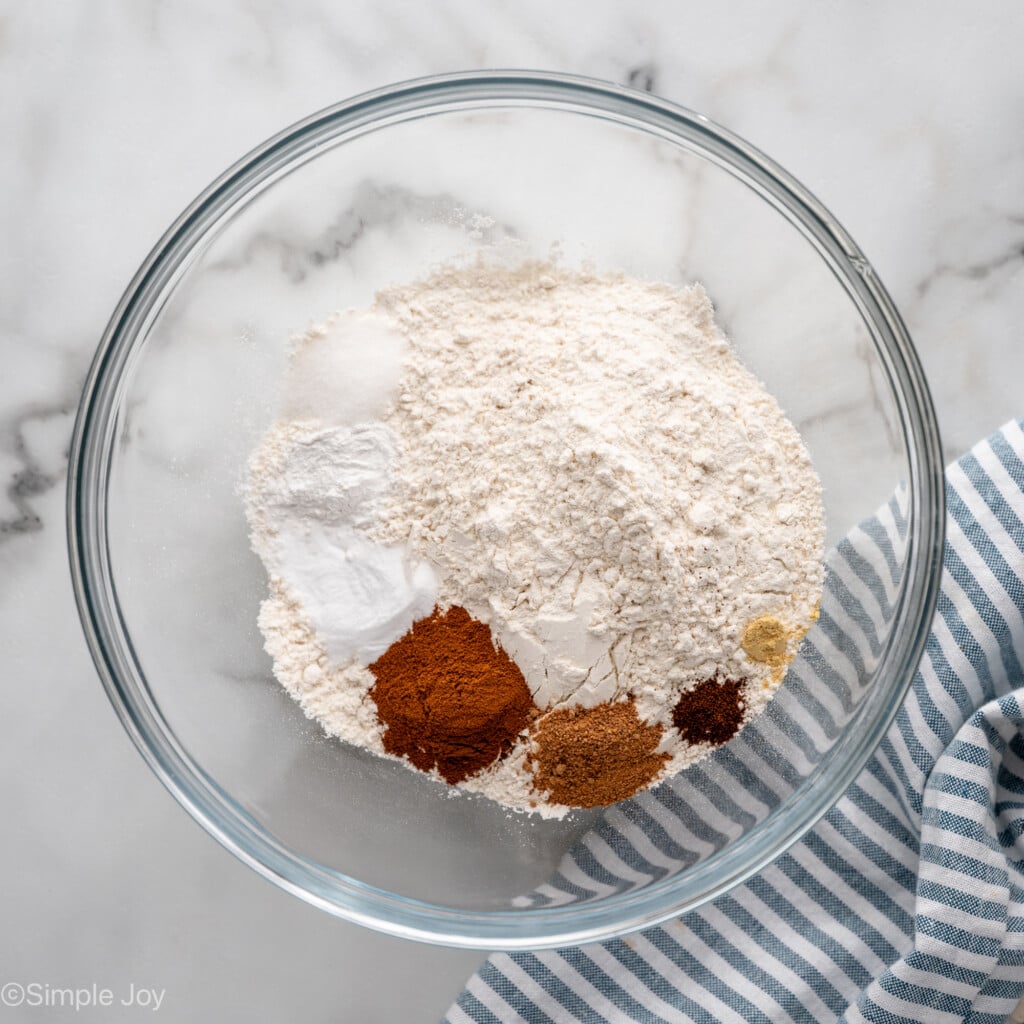 Overhead view of a mixing bowl of dry ingredients for Carrot Cake Cupcakes recipe