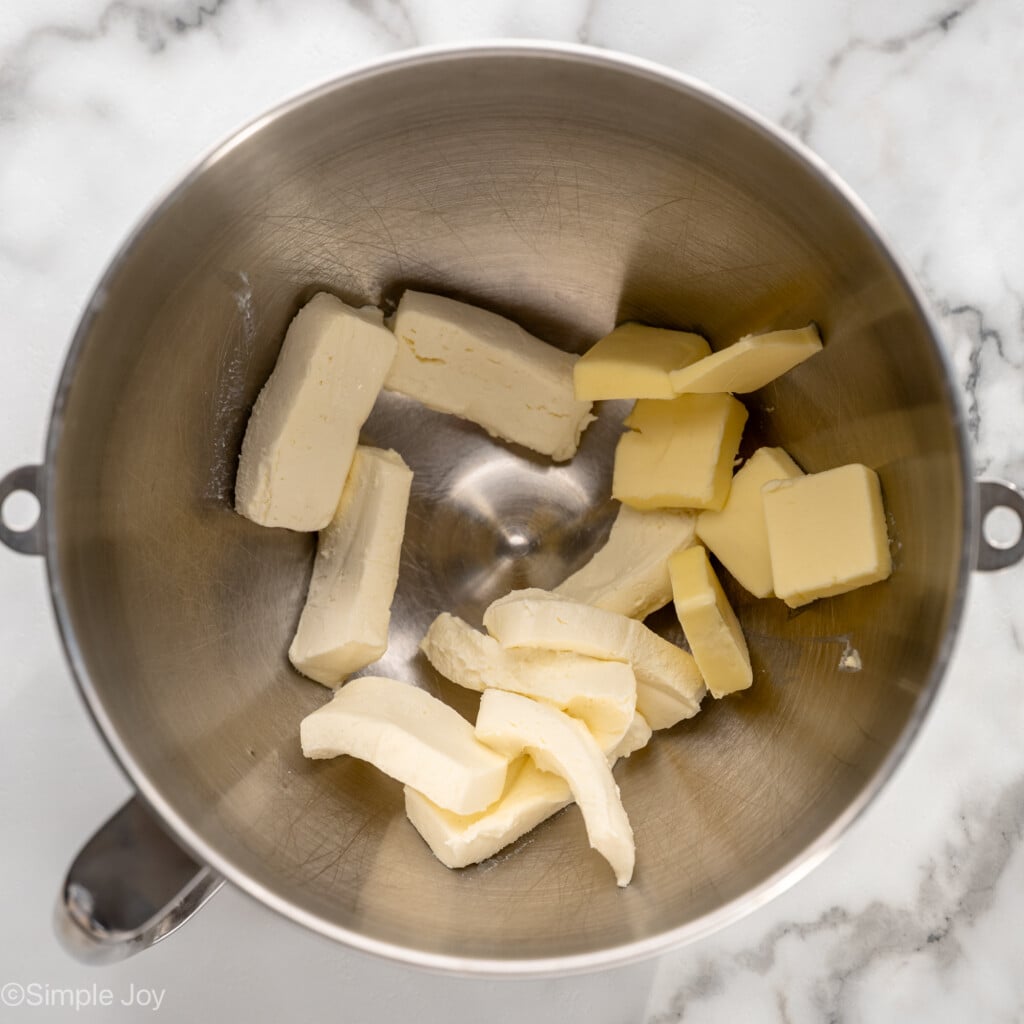 Overhead view of a mixing bowl with ingredients for frosting for Carrot Cake Cupcakes recipe
