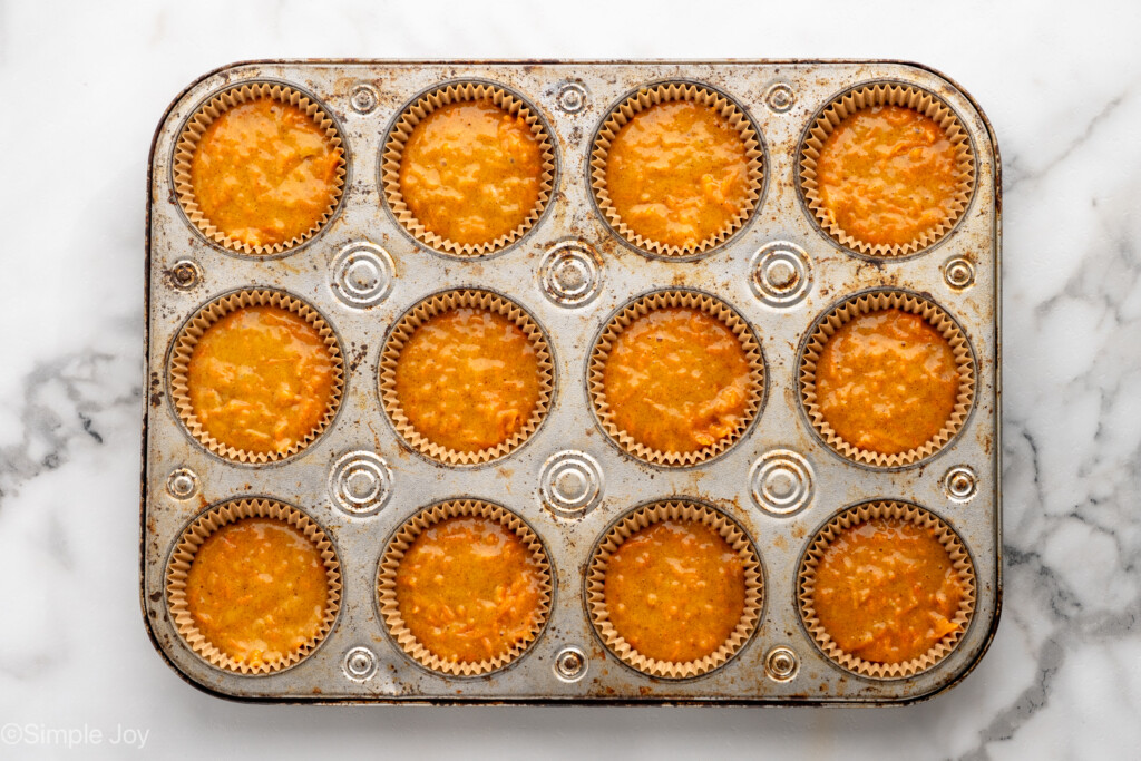 Overhead view of a muffin pan of Carrot Cake Cupcakes before baking