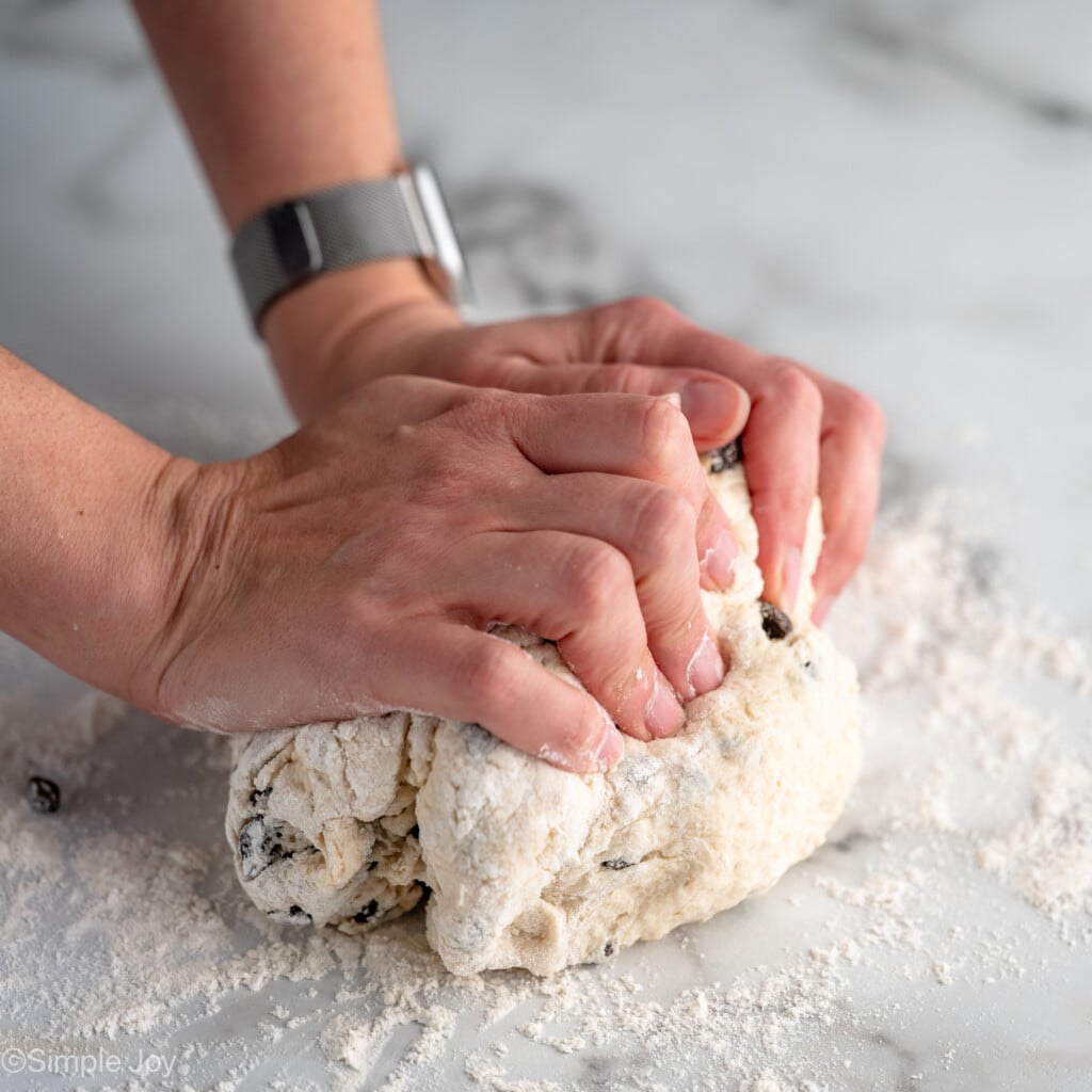 Person's hand kneading dough for Irish Soda Bread recipe