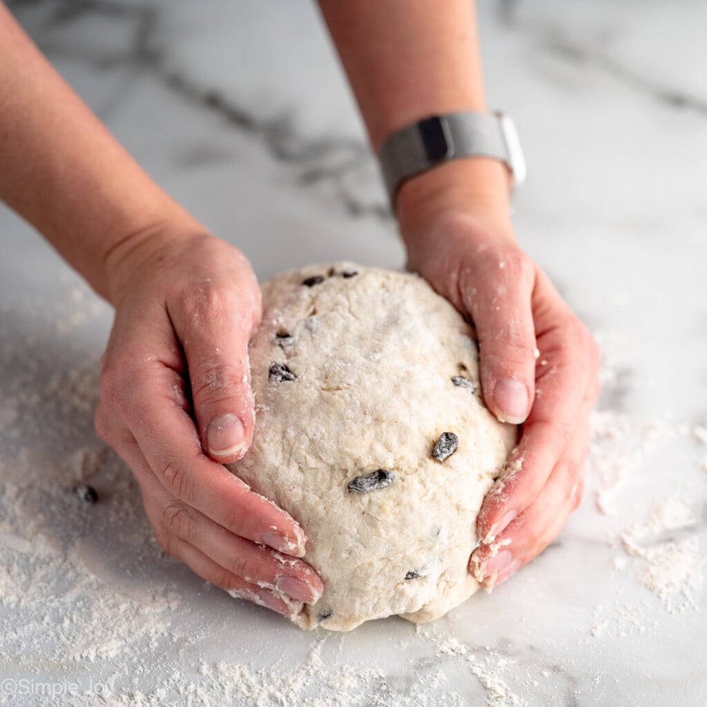 Person's hands shaping dough into loaf for Irish Soda Bread recipe