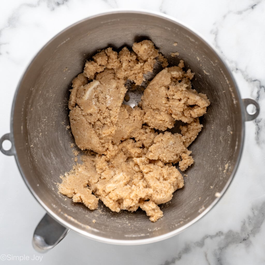 Overhead view of mixing bowl of ingredients mixed together for Oatmeal Raisin Cookies recipe