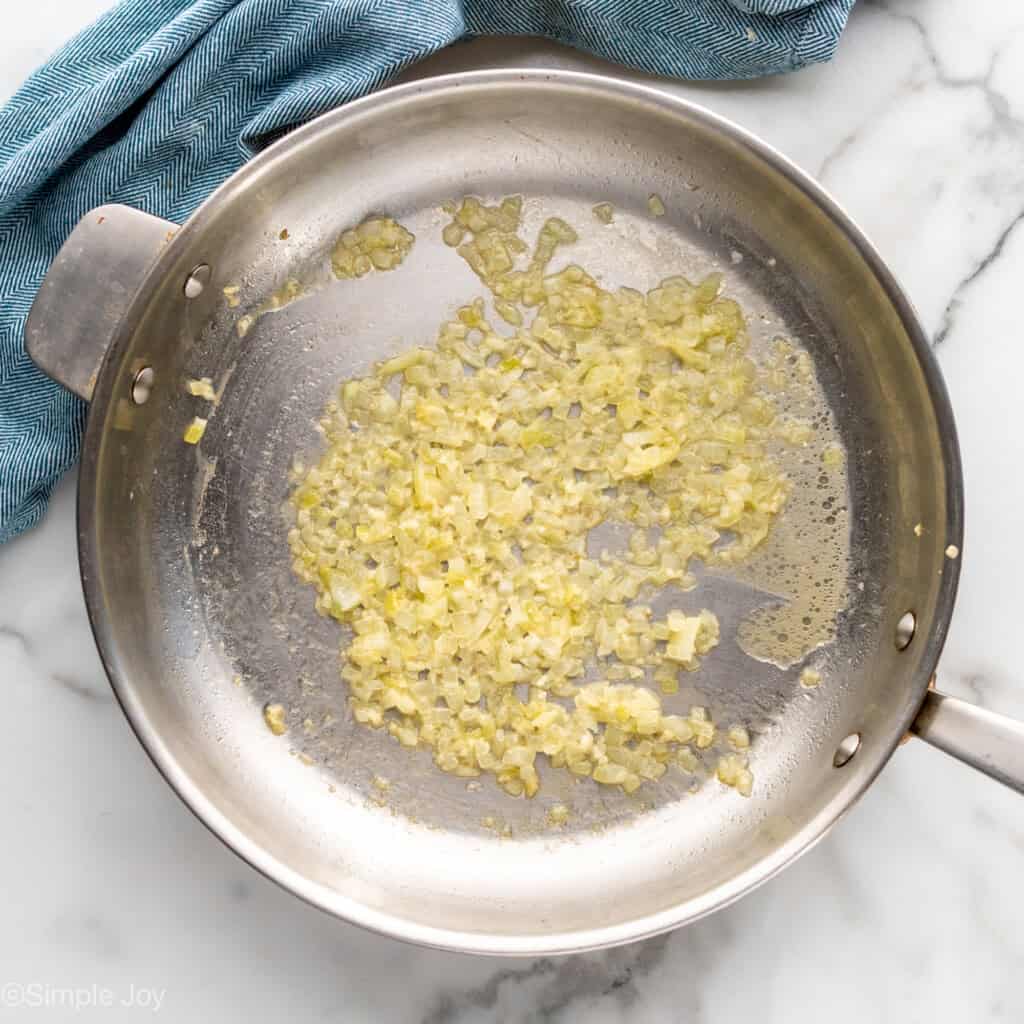 sautéed garlic and onion in a skillet with vodka