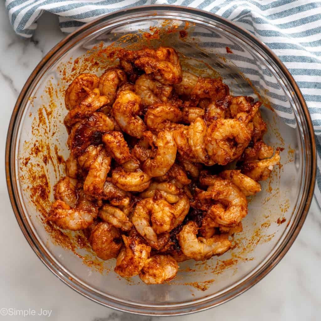 overhead of a bowl of shrimp coated in marinade