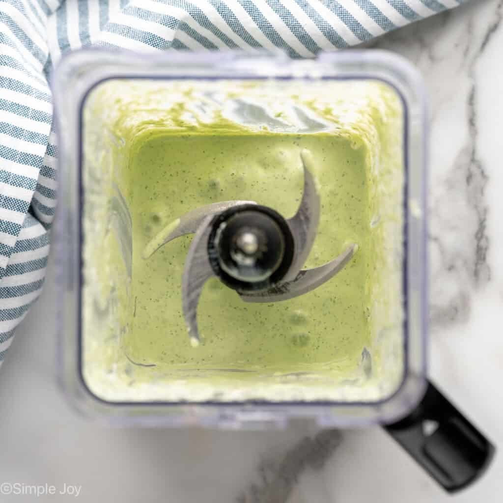 a blender with cilantro lime creama sauce