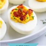 Pinterest graphic for Deviled Eggs with Bacon recipe. Image shows Deviled Eggs with Bacon topped with fresh chives. Text says, "super easy bacon deviled eggs simplejoy.com."
