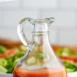 Pinterest graphic for Catalina Dressing. Says "the best Catalina Dressing simplejoy.com" Image shows a jar of Catalina Dressing with plate of salad sitting behind.