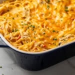 Pinterest graphic for Chicken Spaghetti. Image shows a baking dish of Chicken Spaghetti. Says "super easy Chicken Spaghetti simplejoy.com"