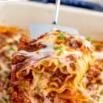 Pinterest graphic for Lasagna Roll Ups recipe. Text says, "the best Lasagna Roll Ups simplejoy.com." Image shows spatula lifting Lasagna Roll Up from baking dish of Lasagna Roll Ups recipe