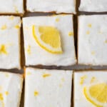 Pinterest graphic for Lemon Sugar Cookie Bars recipe. Image shows overhead view of sliced Lemon Sugar Cookie Bars garnished with lemon zest and slices of lemon. Text says, "amazing lemon cookie bars simplejoy.com."