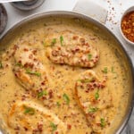 Pinterest image for Marry Me Chicken. Says "the best Marry Me Chicken simplejoy.com" Image shows overhead of skillet of Marry Me Chicken with bread sitting beside