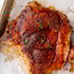 Overhead of a baked pork chop on a baking sheet