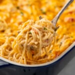 Serving spoon scooping Chicken Spaghetti out of baking dish