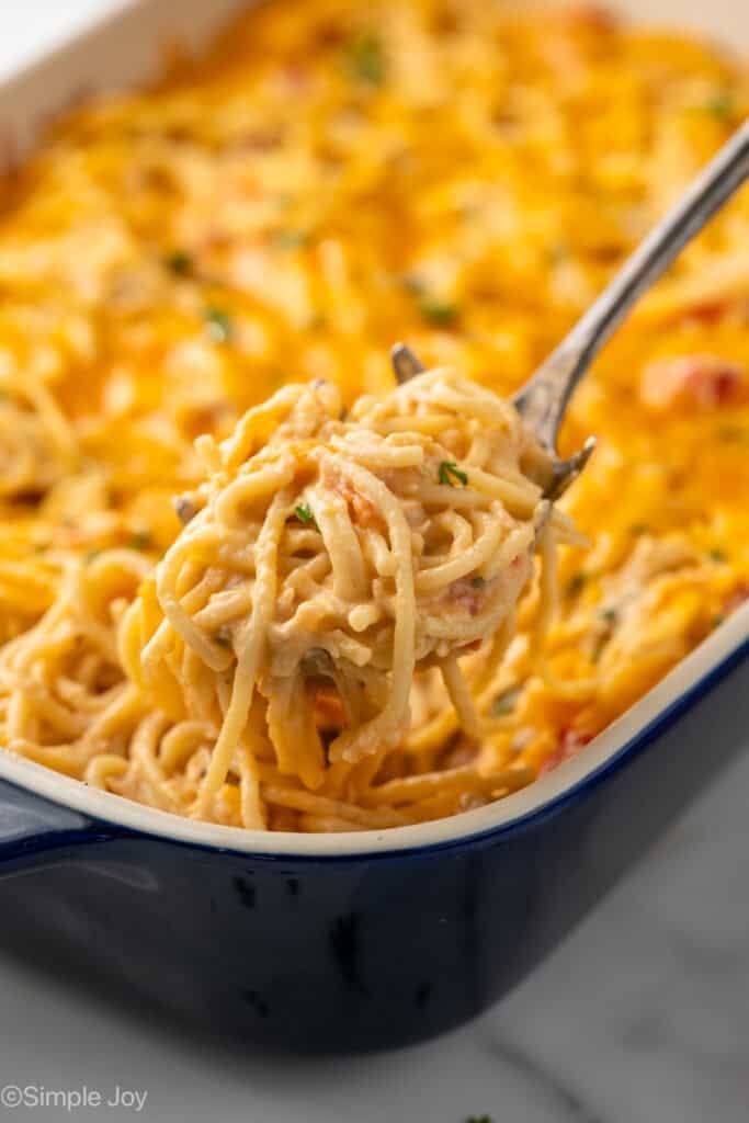 Serving spoon scooping Chicken Spaghetti out of baking dish