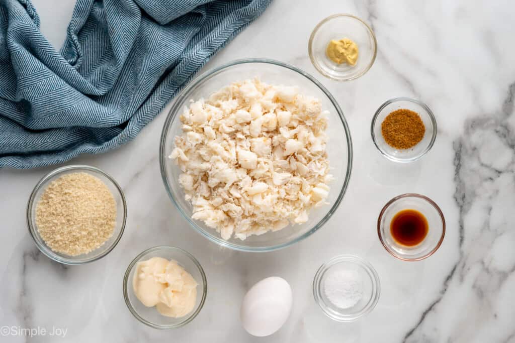 overhead of crab cake ingredients in glass bowls