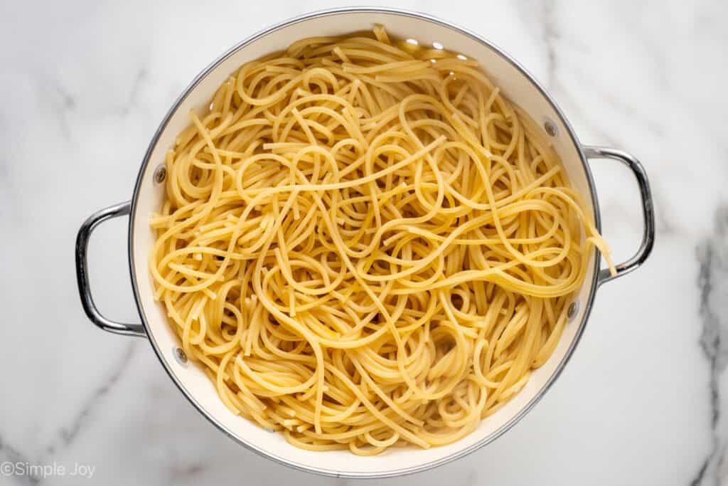 overhead of cooked spaghetti in a colander to make Chicken Spaghetti