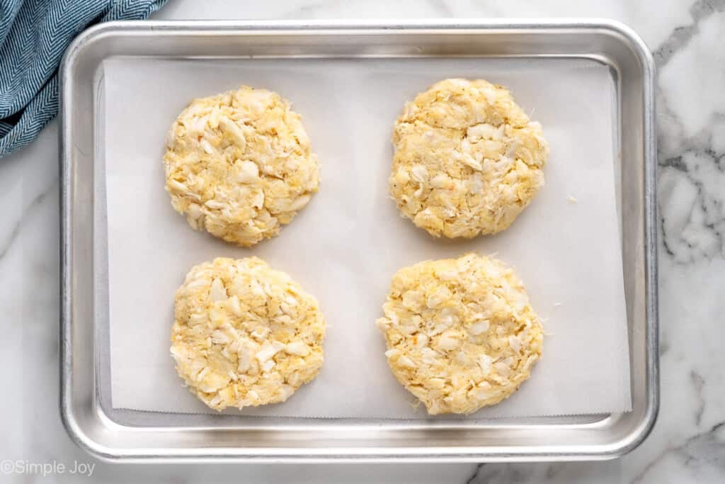 overhead of crab cakes on a baking sheet
