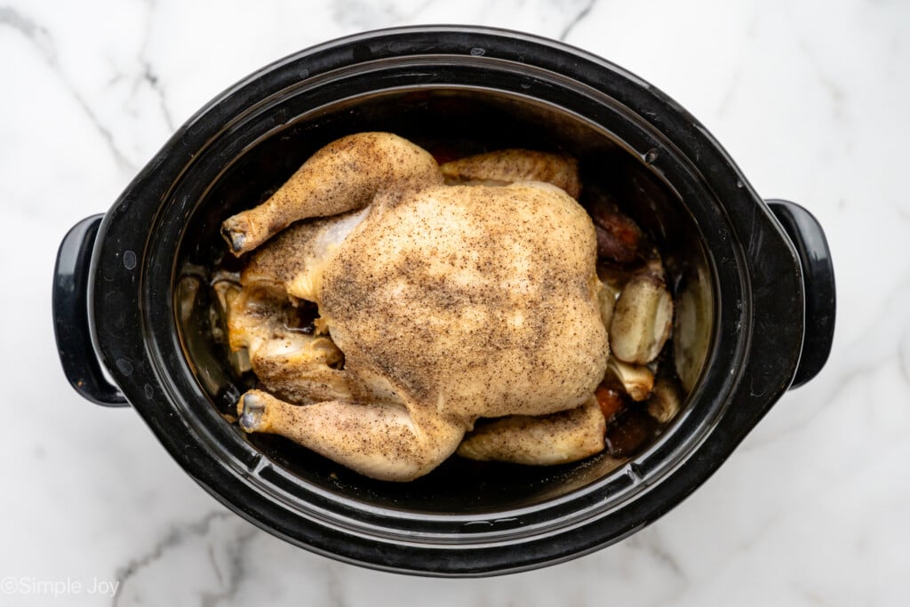 overhead of slow cooker with whole chicken for making Crockpot Whole Chicken