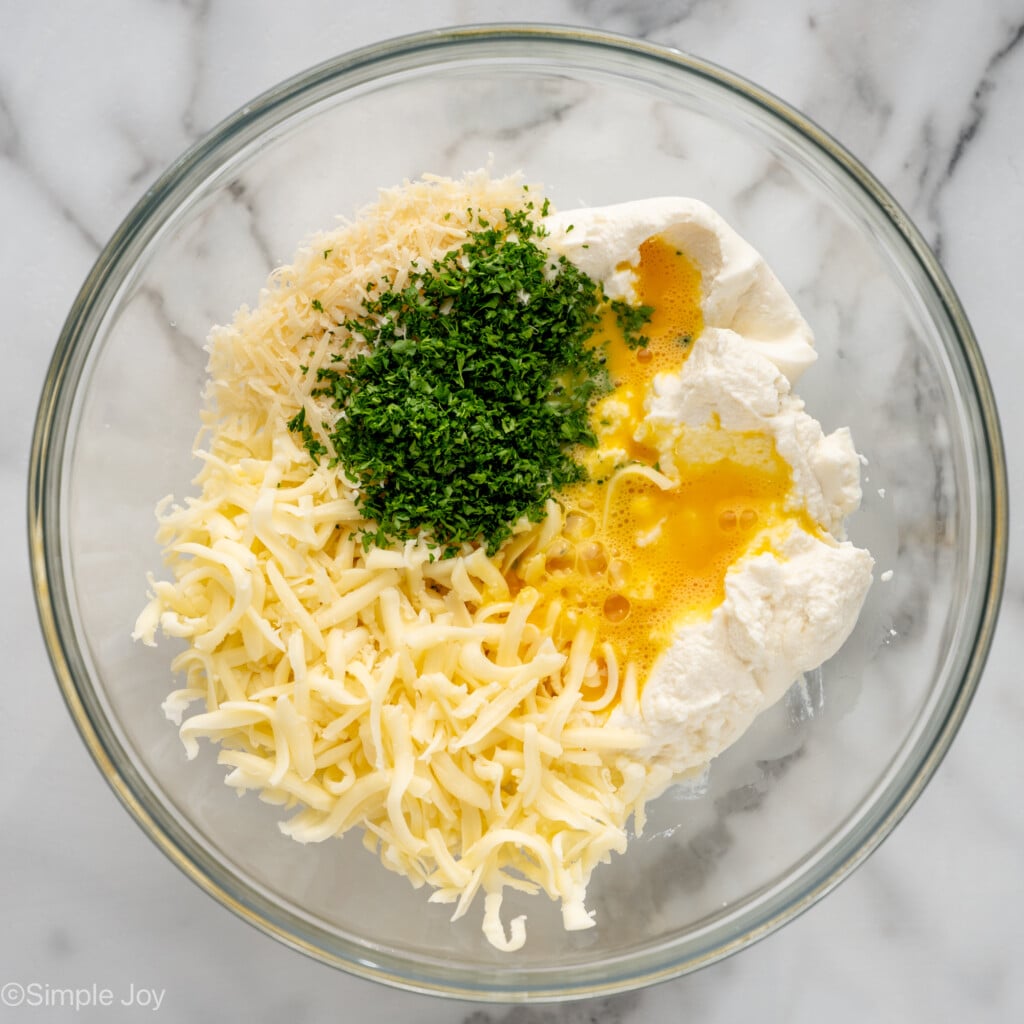 Overhead view of a mixing bowl of ingredients for Lasagna Roll Ups recipe