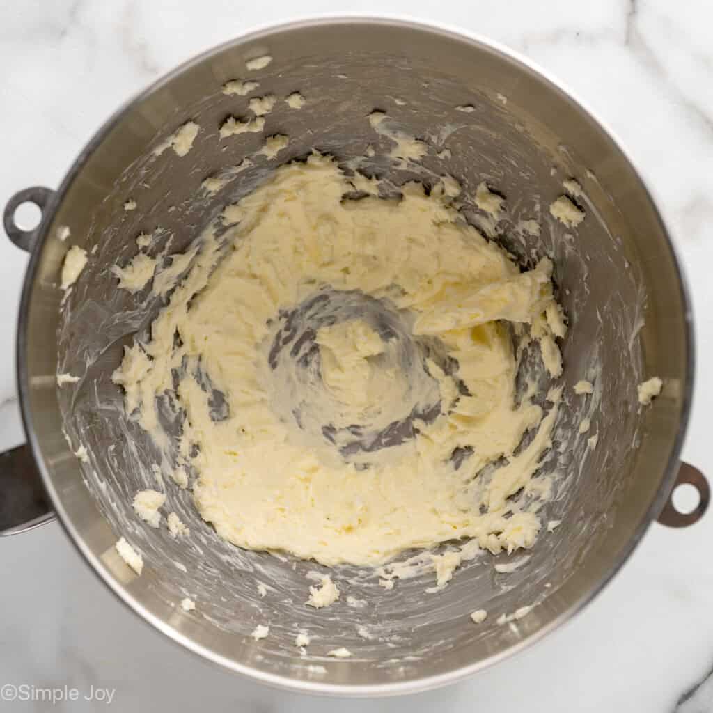 Overhead view of a mixing bowl of creamed butter for Lemon Sugar Cookie Bars frosting recipe