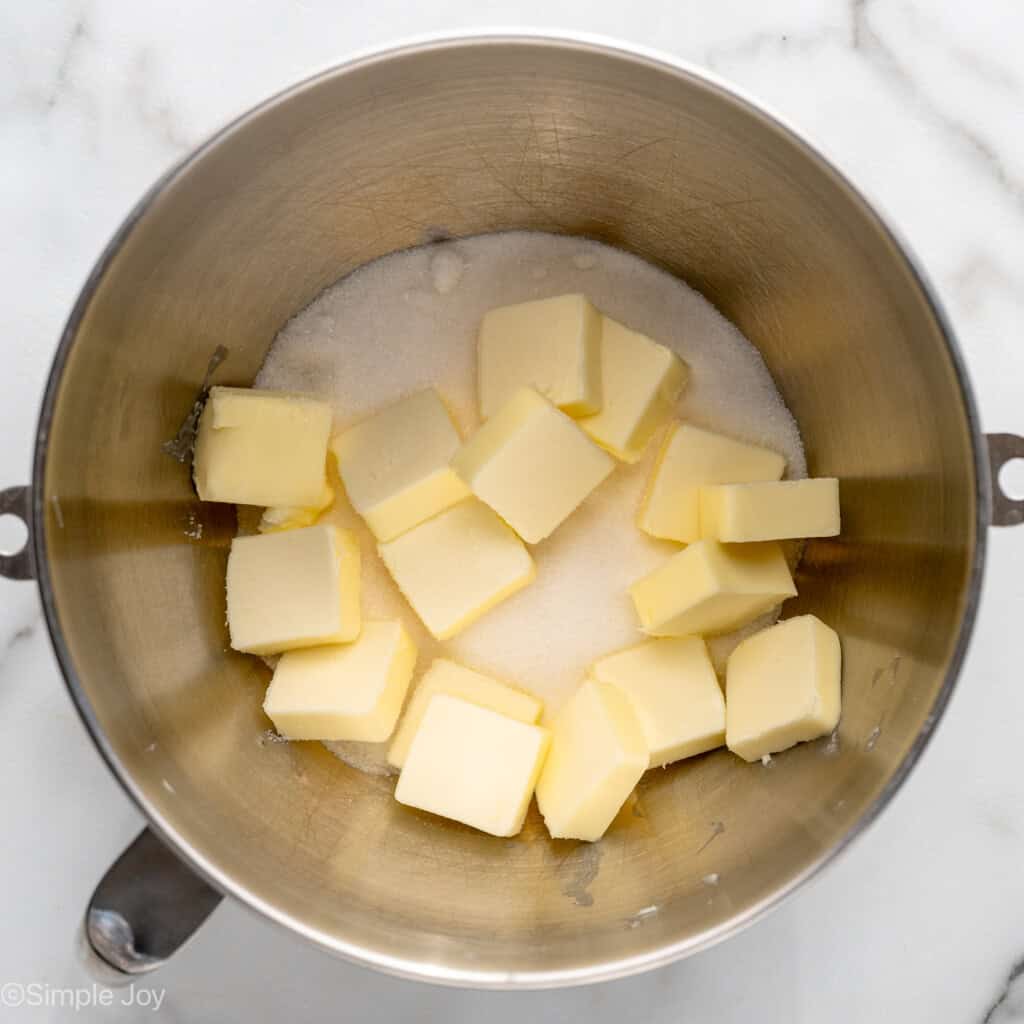 Overhead view of a mixing bowl of sugar and diced butter for Lemon Sugar Cookie Bars recipe