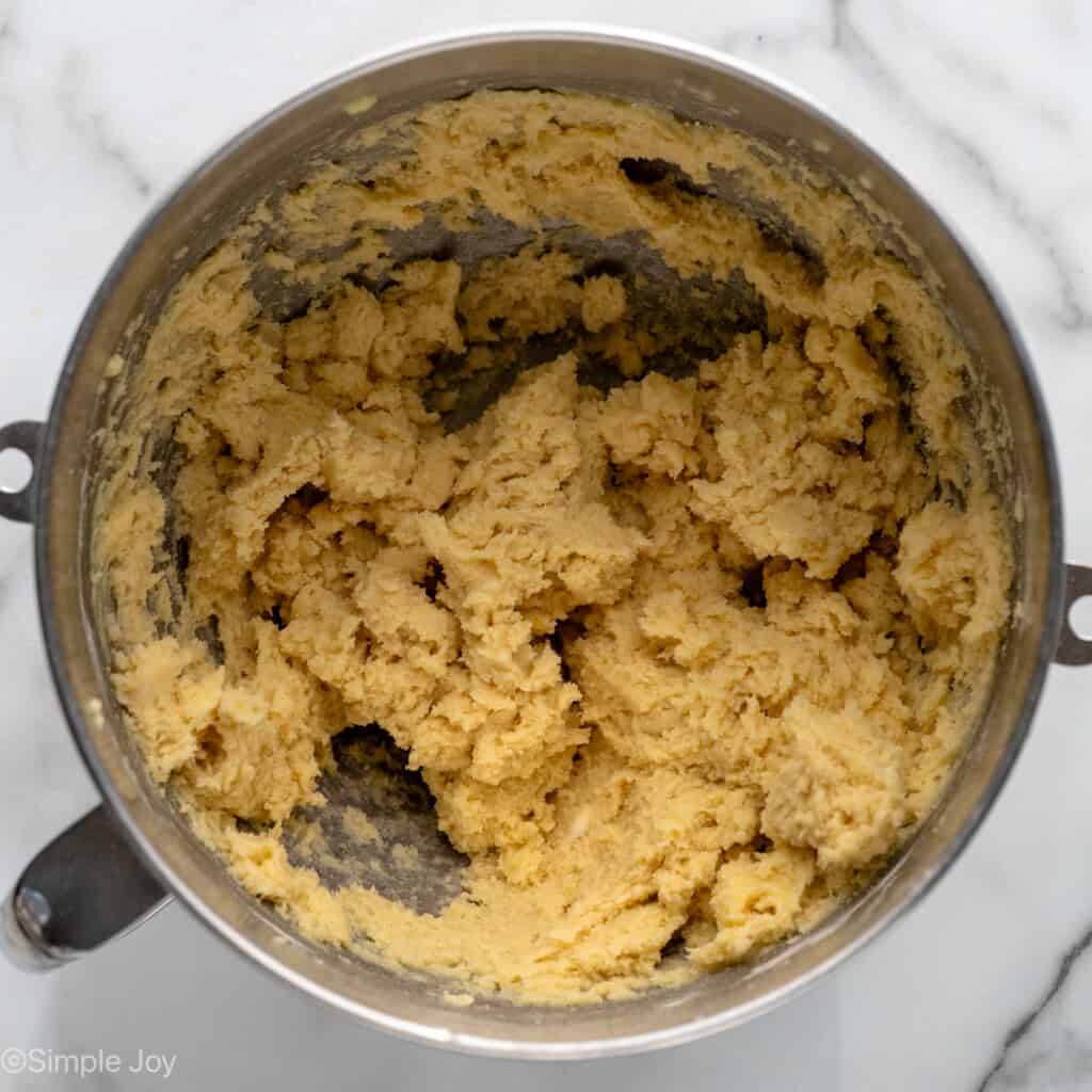 Overhead view of a mixing bowl of crust ingredients mixed together for Lemon Sugar Cookie Bars recipe